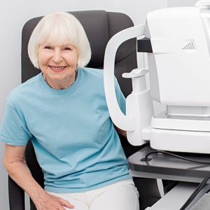 senior woman by eye test machine